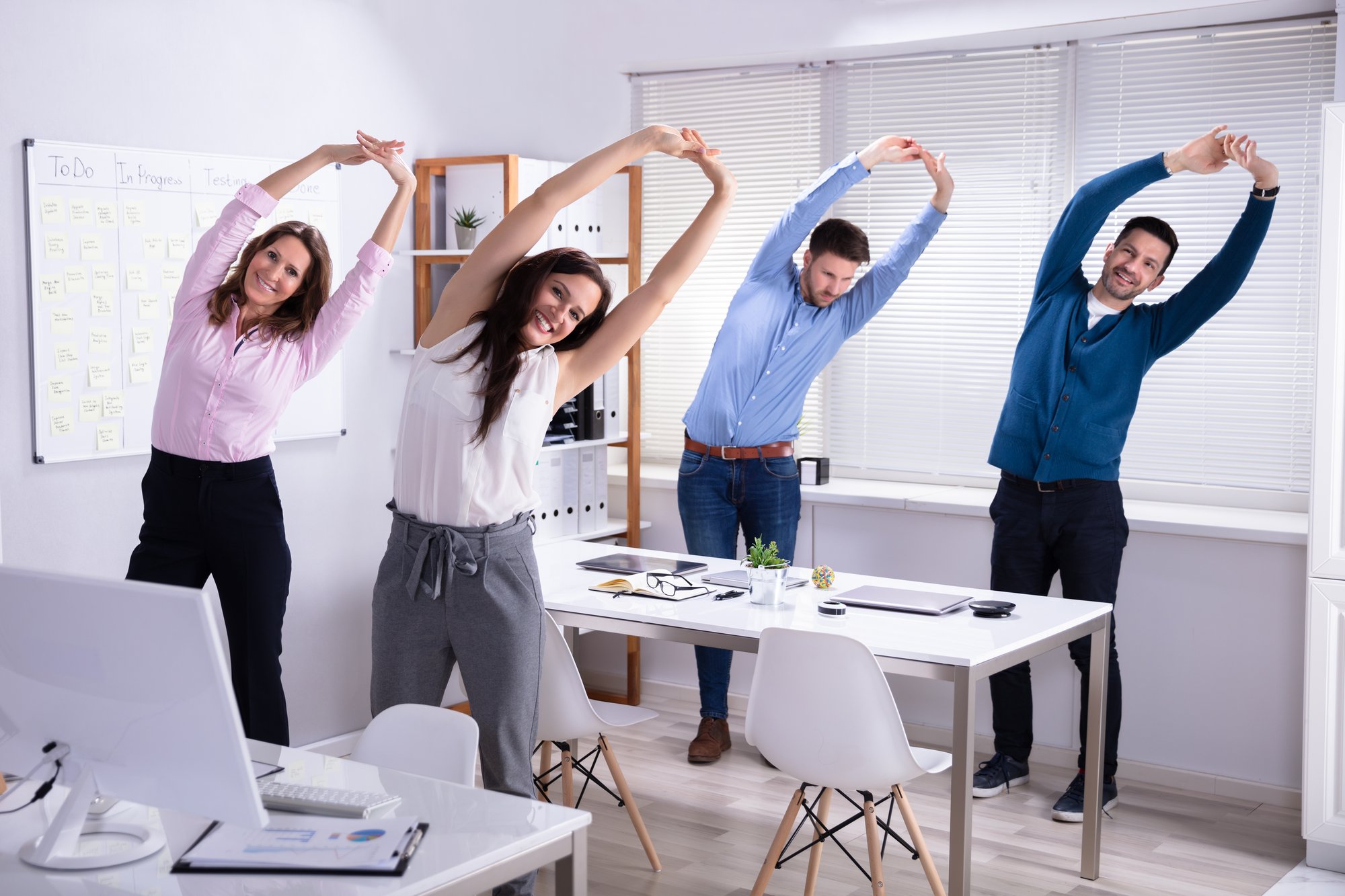 Businesspeople-Doing-Exercise-Behind-Desk-1144374119_7718x5145 Businesspeople-Doing-Exercise-Behind-Desk-1144374119_7718x5145