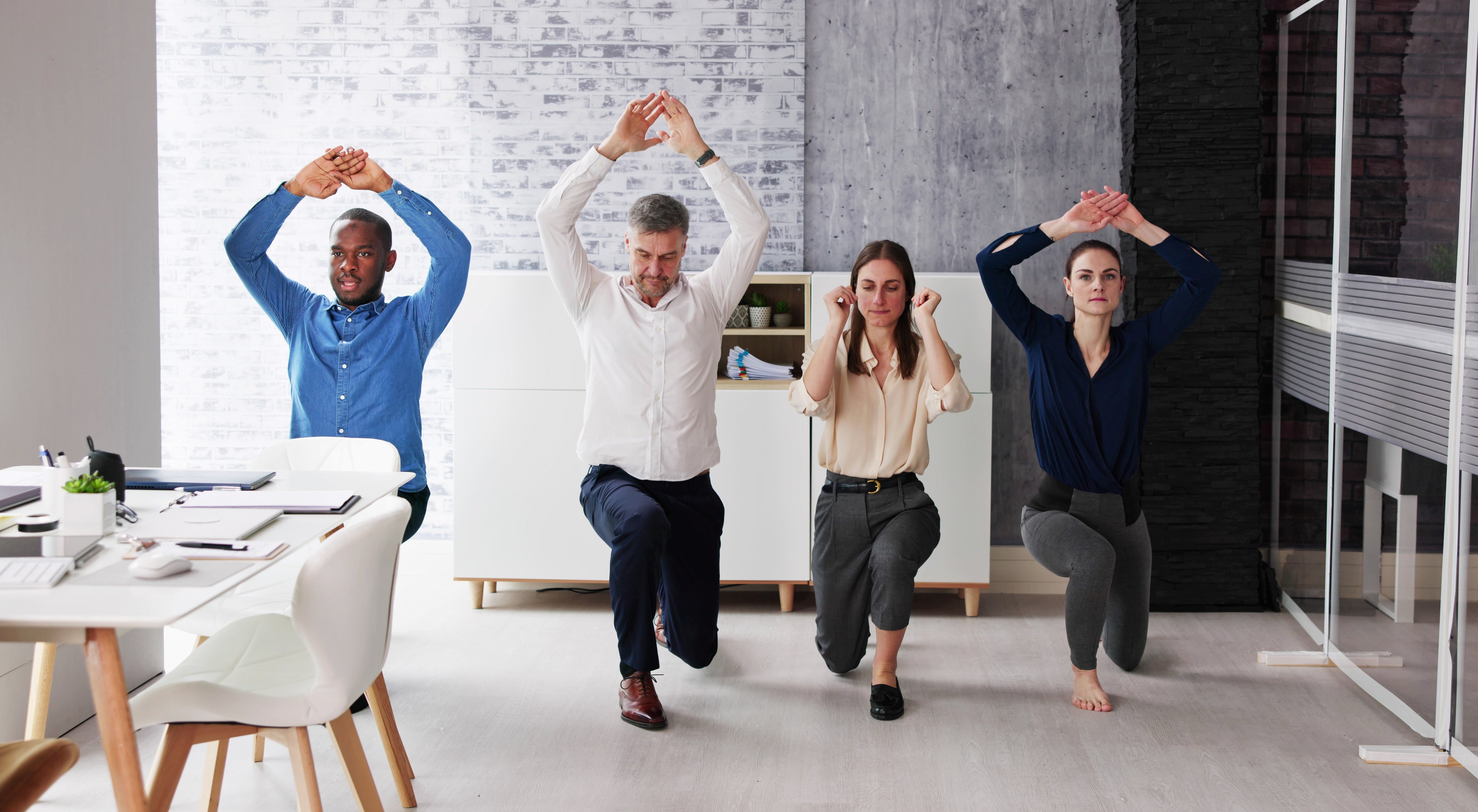 Happy-Young-Businesspeople-Doing-Stretching-Exercise-1458140489_4262x2341