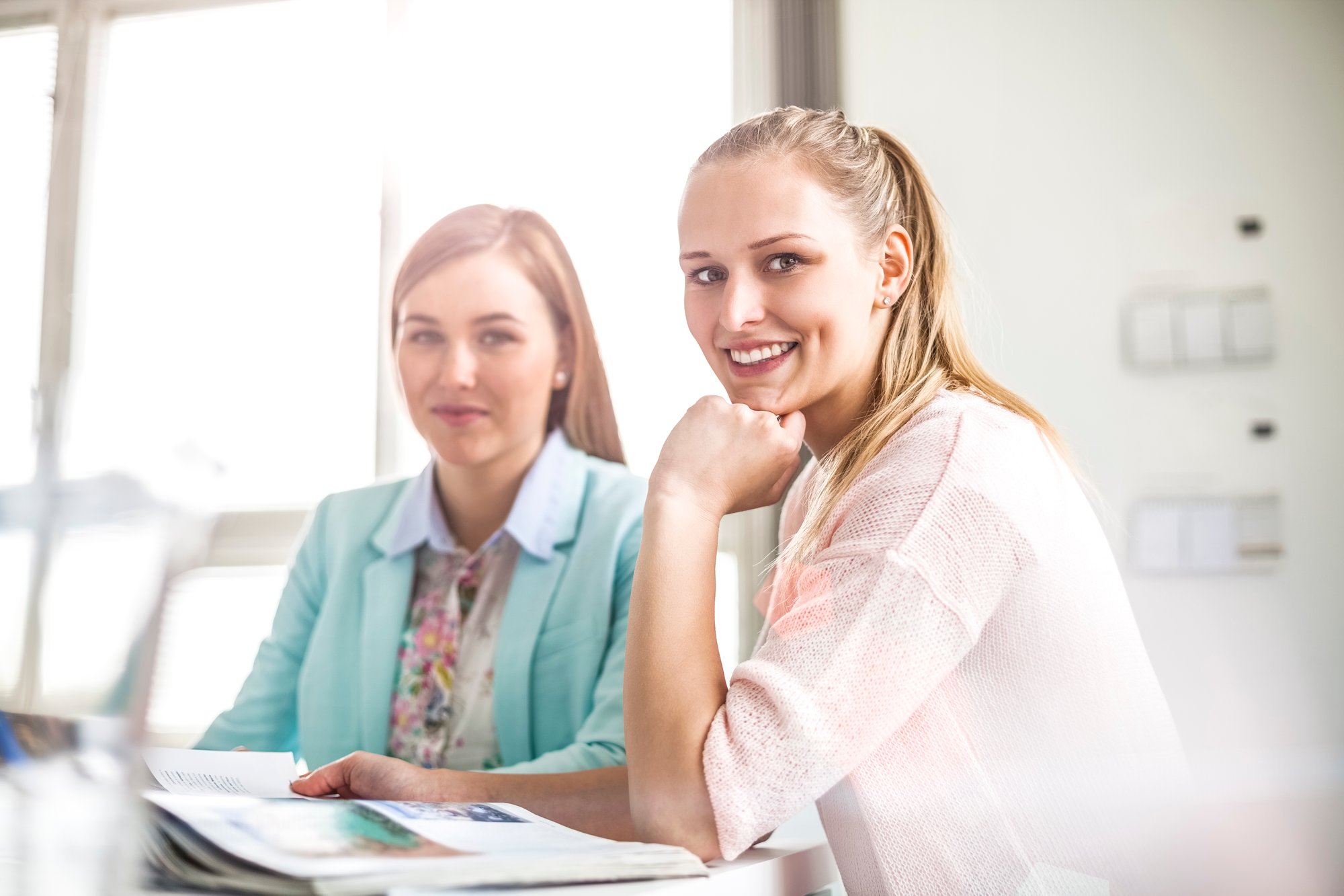Portrait-of-young-female-fashion-designer-with-colleague-in-office-625903940_5121x3414
